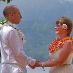 Closed ti leaf lei with white orchid wrap around and rainbow plumeria lei